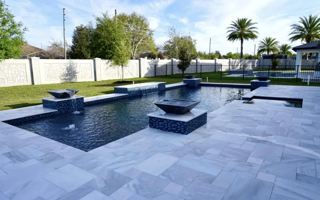 Custom inground concrete pool with water features built by a professional pool builder in Orlando.