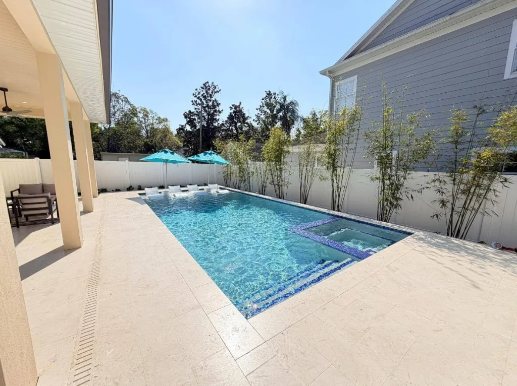 Modern rectangular concrete pool under construction timeline planning in Orlando backyard