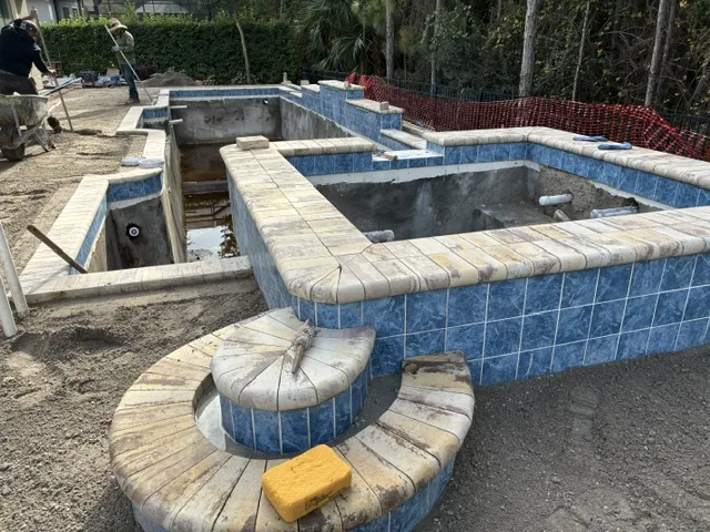 Older swimming pool undergoing a major remodel with structural and surface renovations